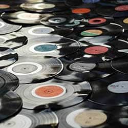 lots of vinyls spread on a surface on top of each other